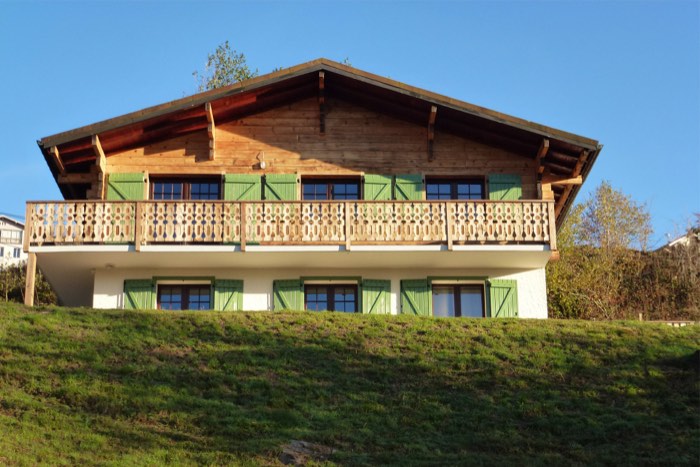 Le chalet dans son écrin de verdure en été
